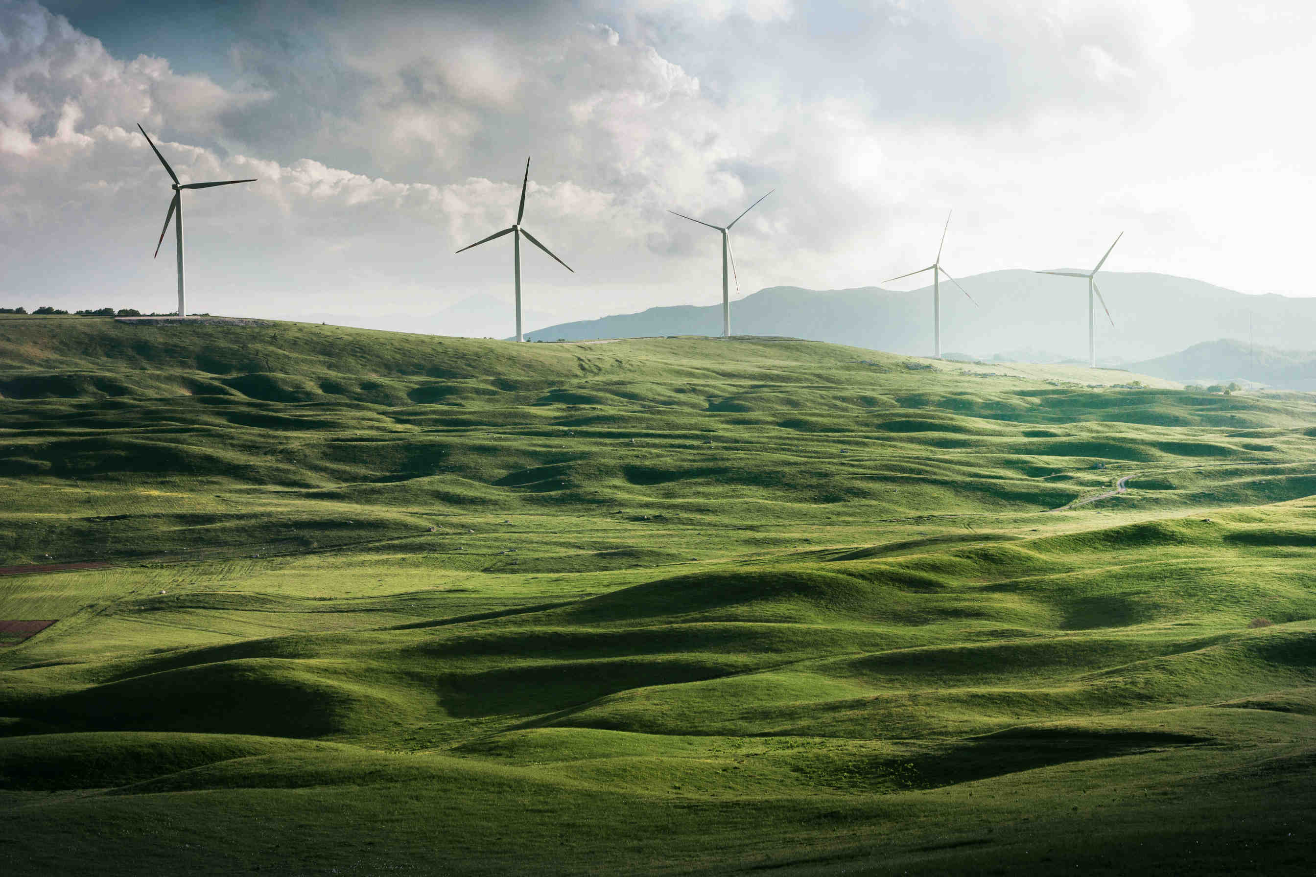 A scenic view of renewable energy sources including wind turbines and solar panels